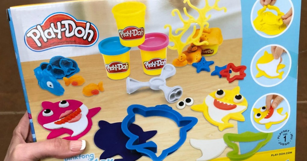 hand holding up baby shark play doh set box