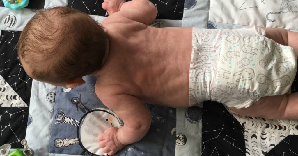 Brandless Diapers on baby laying on floor