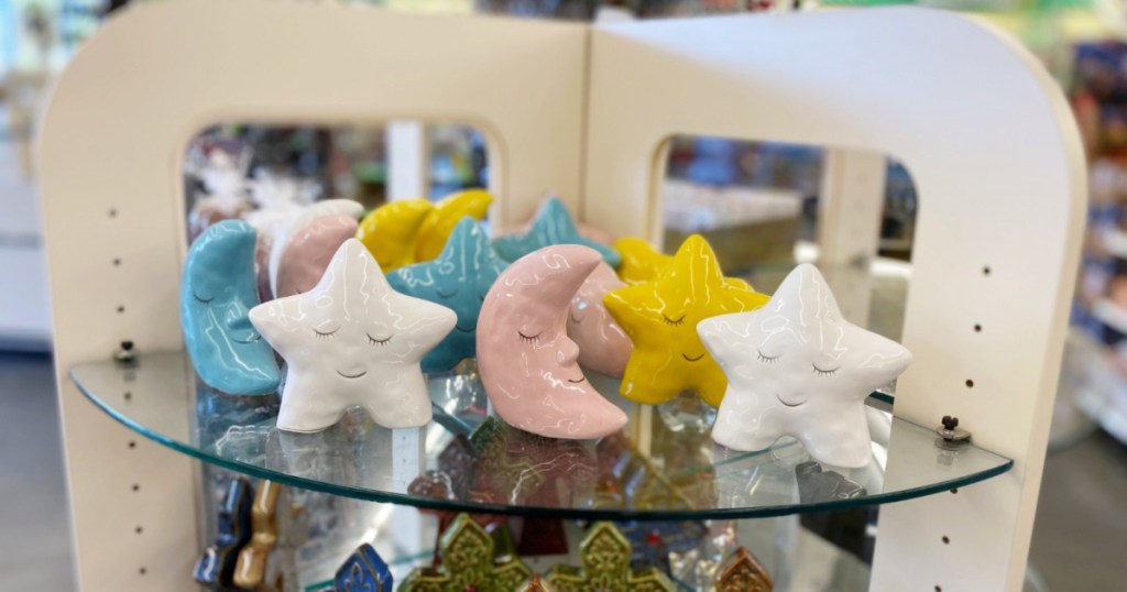 pastel ceramic star and moon decor on shelf at dollar tree