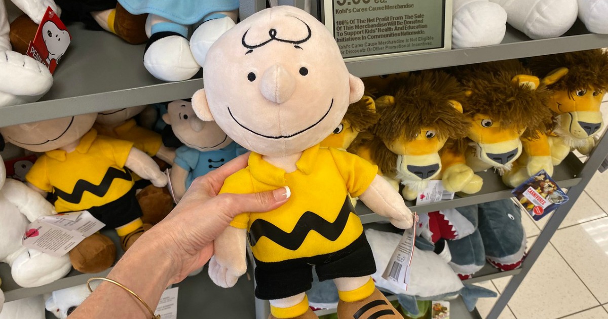 woman holding Charlie Brown Kohl's Cares Plush toy