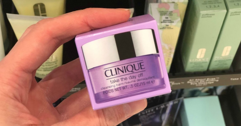 woman holding Clinique Take the Day off Cleansing Balm