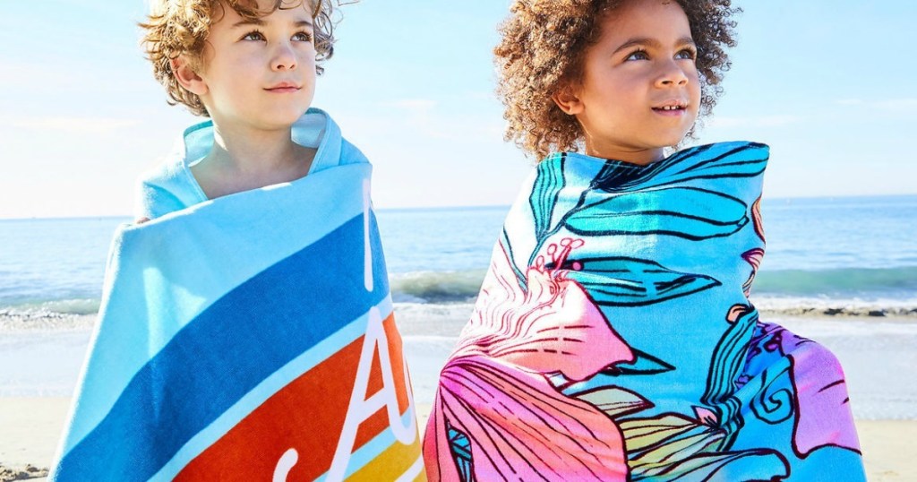 two kids wrapped around with Disney Personalized Beach Towel