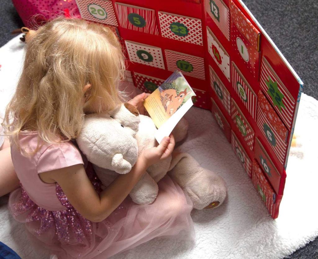 girl reading a book from the Disney Storybook Advent Calendar