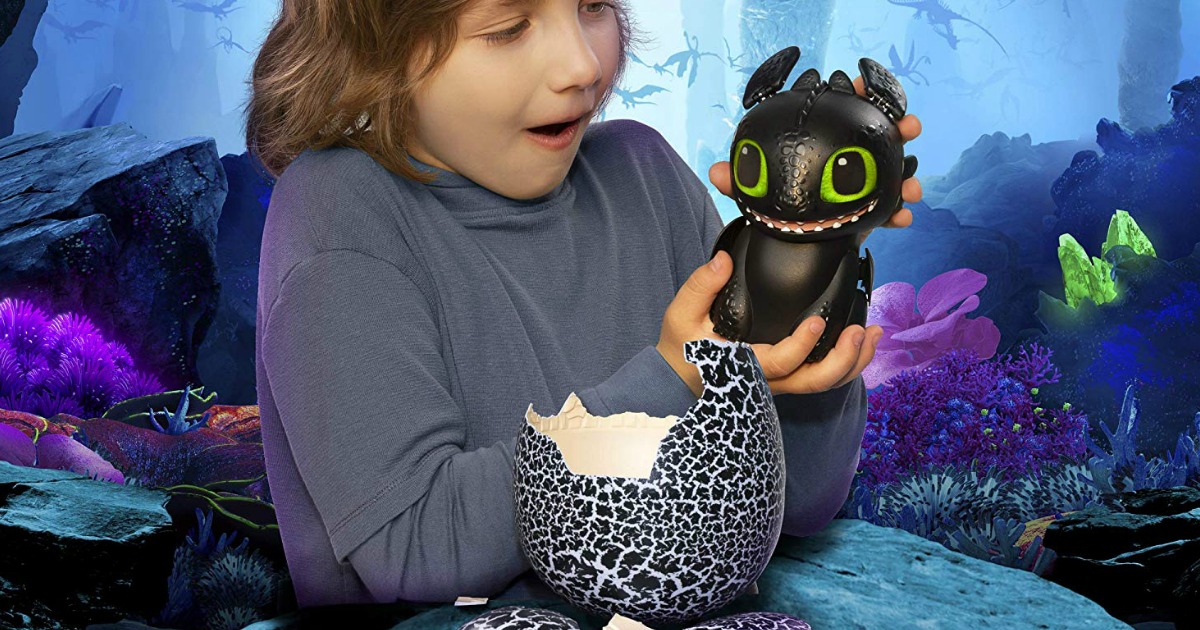 boy playing with interactive toothless hatching dragon