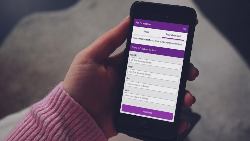 person holding iphone with zulily price match form on screen