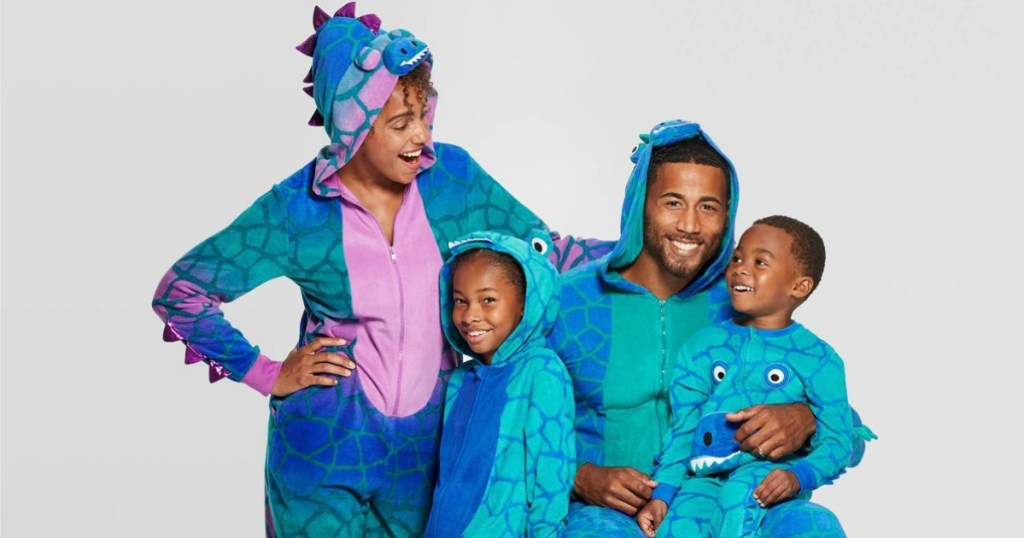 family wearing matching dinosaur union suits