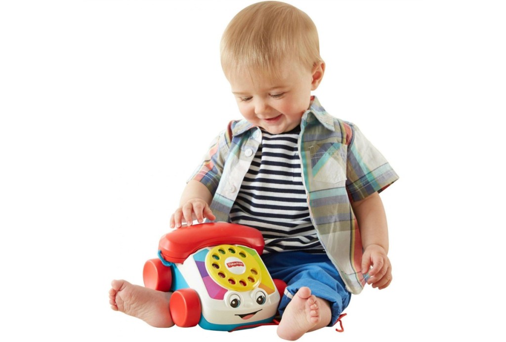 little boy plaing with Fisher-Price Chatter Telephone