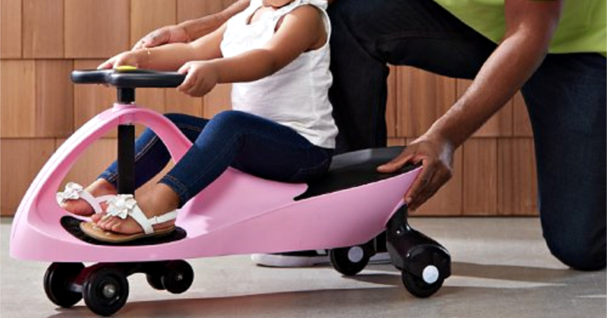 girl riding pink swing car ride on