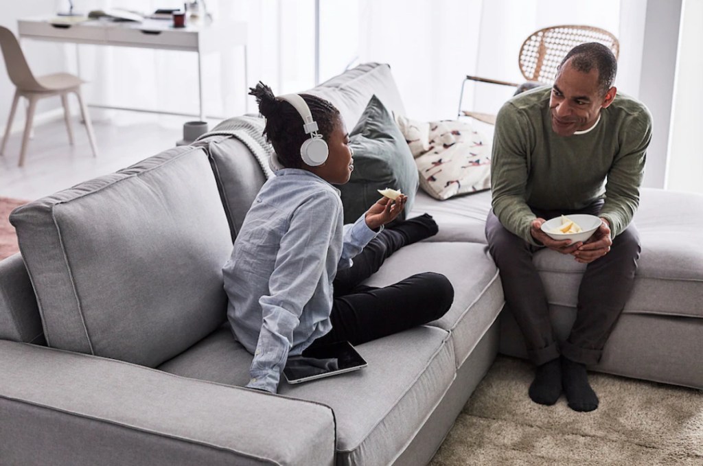 family sitting on gray sectional couch sofa from IKEA