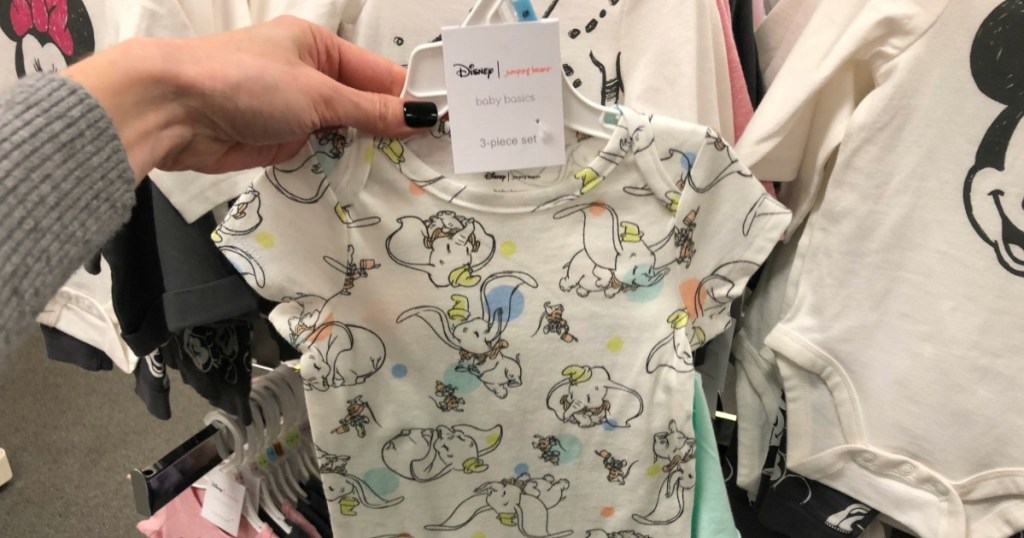 WOman holding Disney baby bodysuit