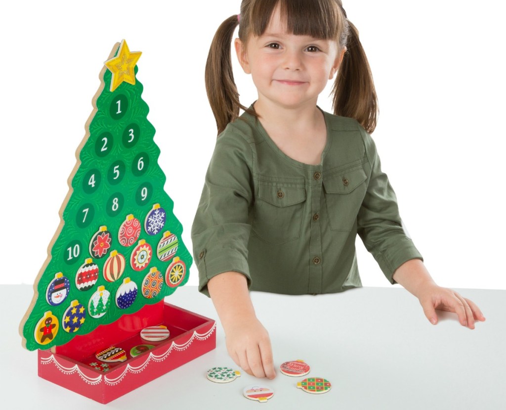 girl playing with Melissa and Doug advent calendar