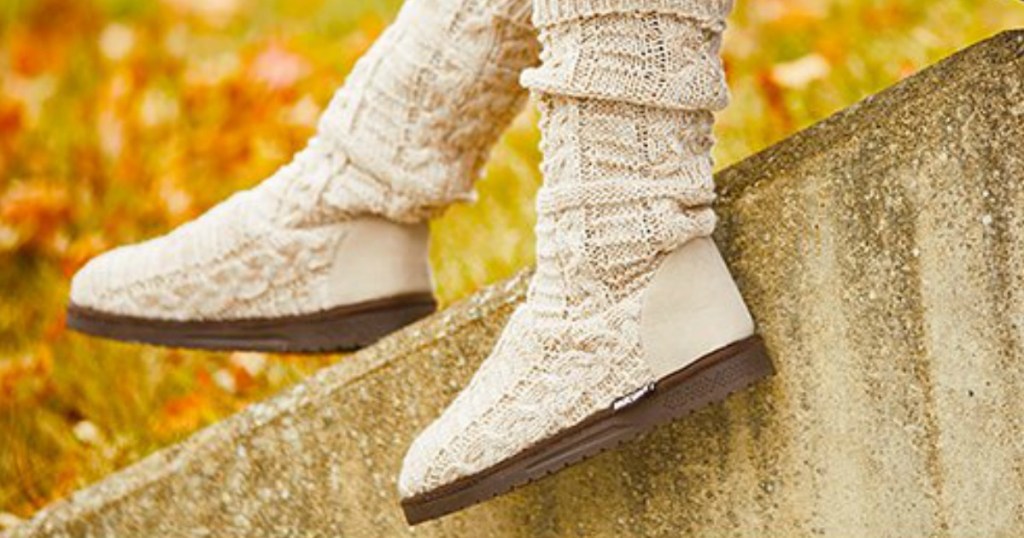 Woman wearing beige/ivory knitted boots in Fall scene