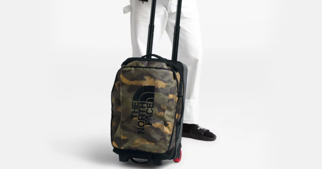 man holding north face duffel bag