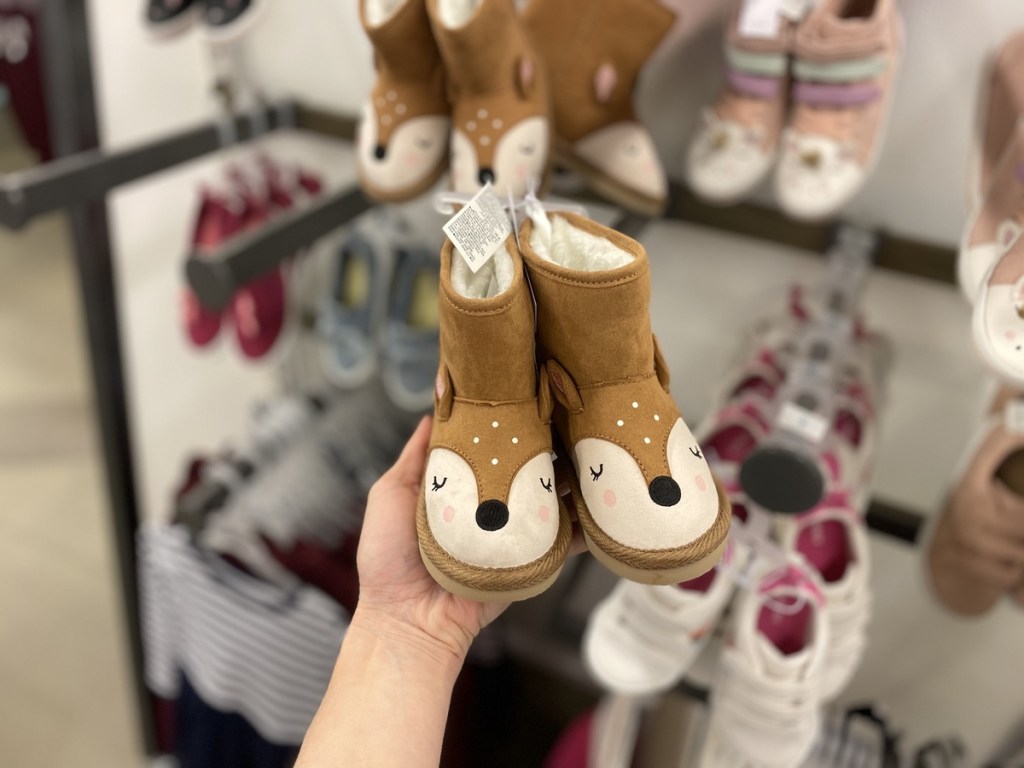 hand holding Old Navy Deer Boots