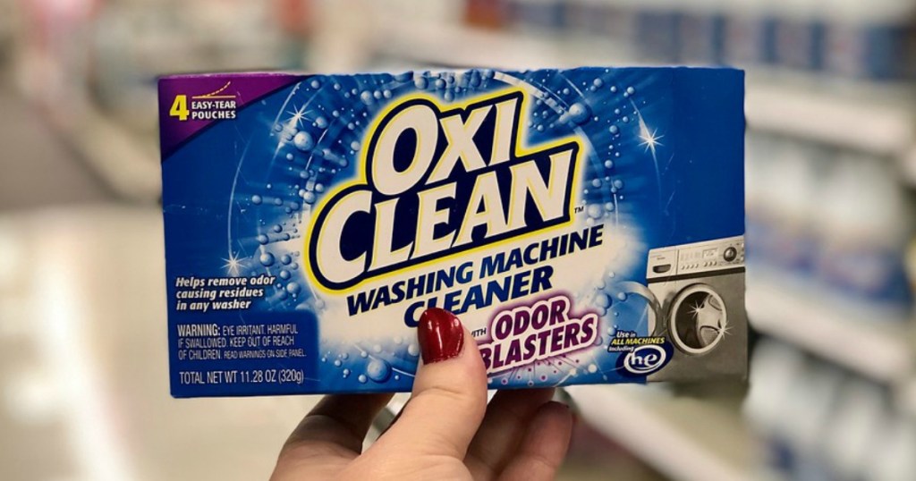 someone holding Oxiclean odor blasters 