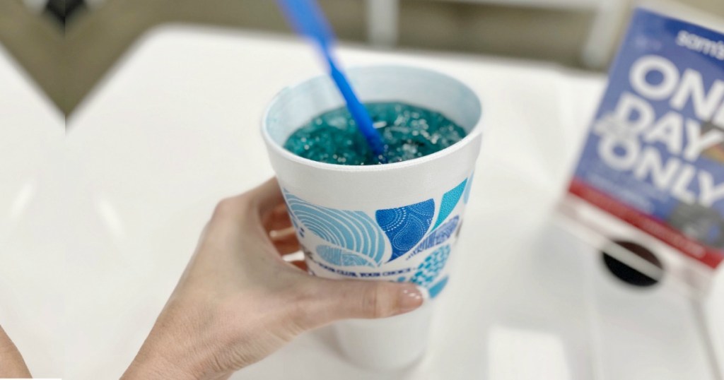 Woman holding cup of Blue Mountain Dew Berry Monsoon