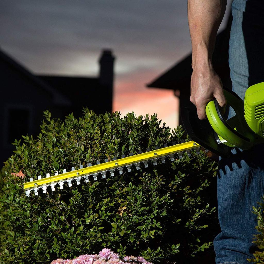 man using Sun Joe Hedge Trimmer