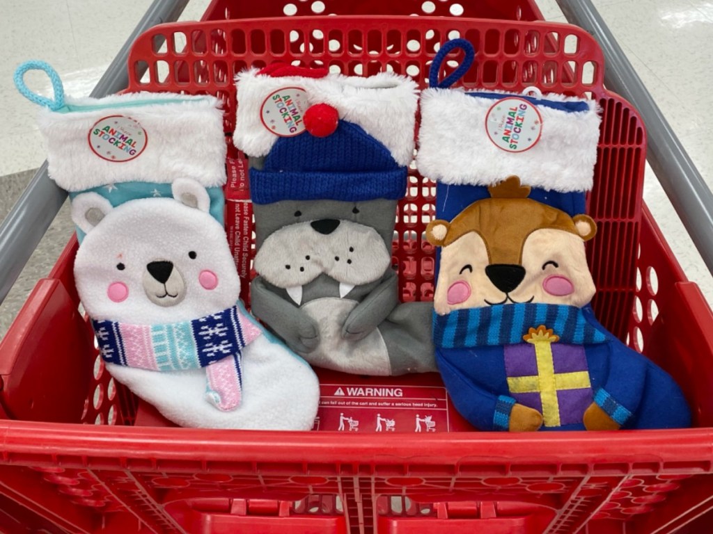 Three animal themed holiday stockings in red Target cart, in-store