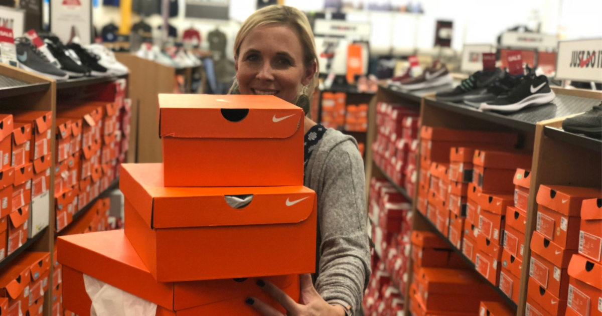 woman holding nike boxes at store