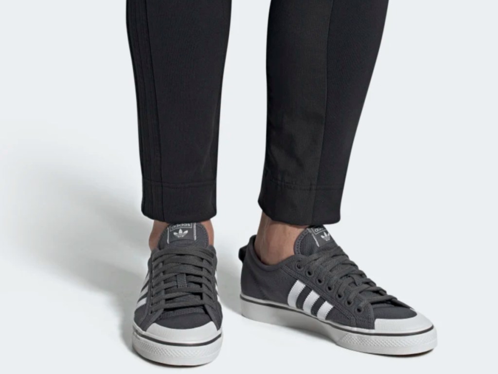 legs modeling gray and white adidas shoes