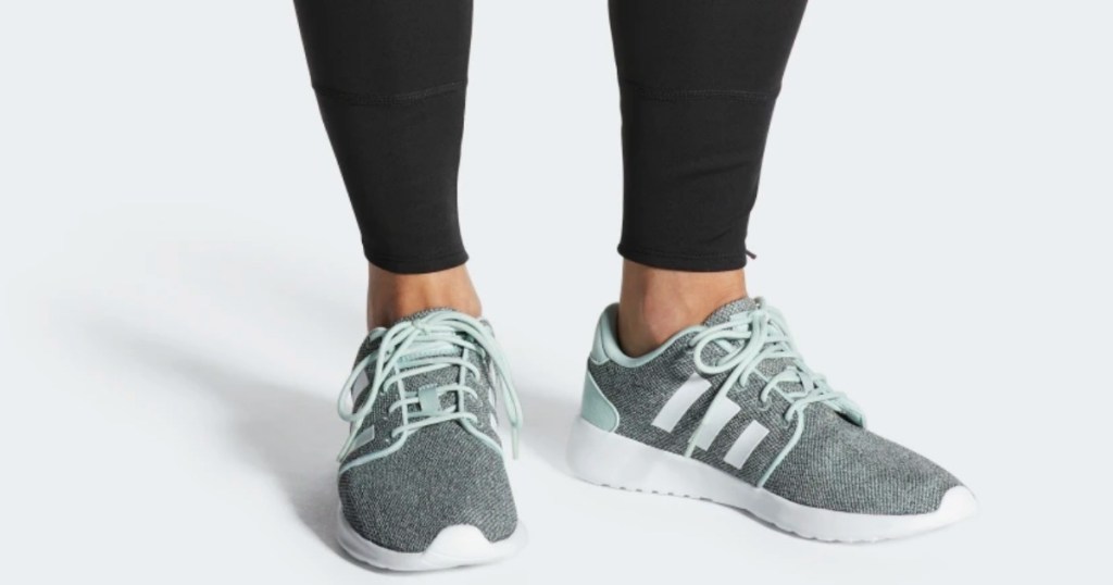 woman wearing adidas racer shoes