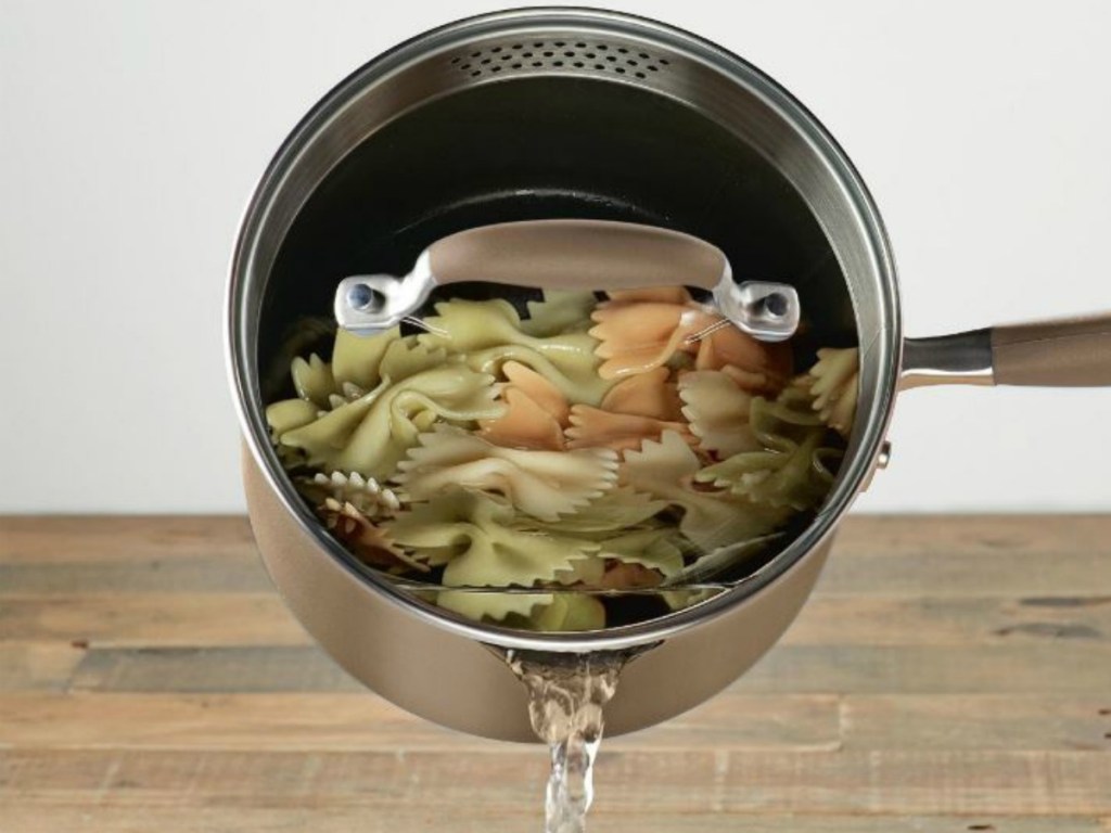 pot with water pouring into sink