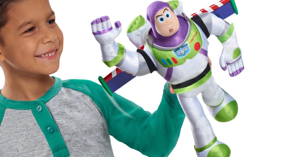 little boy holding buzz lightyear high flying plush