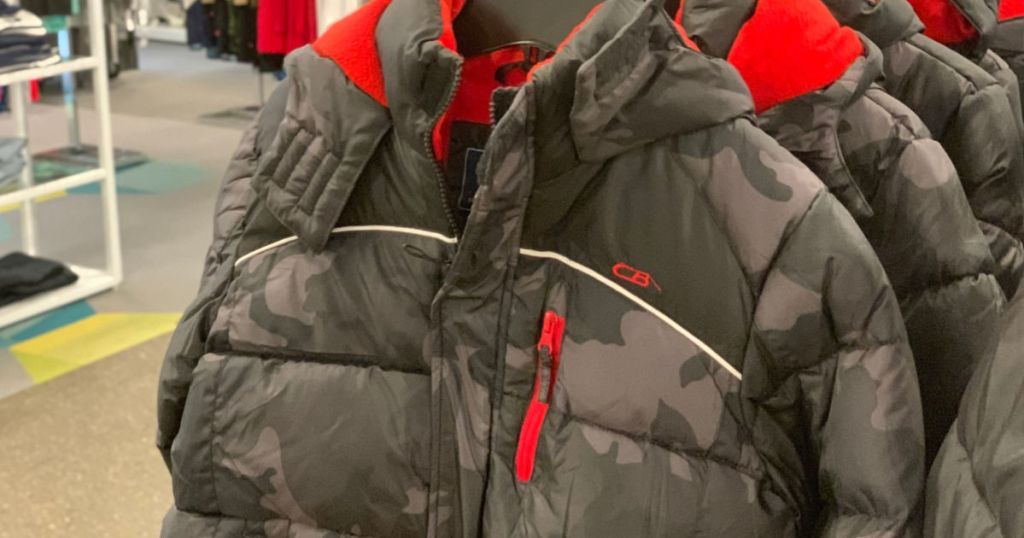 grey and black camo puffer jacket hanging in store