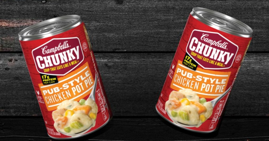 two cans of soup in front of wood background