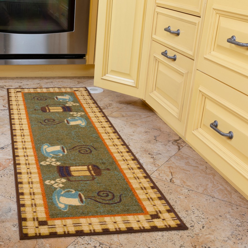 coffee cups runner rug in front of kitchen cabinets