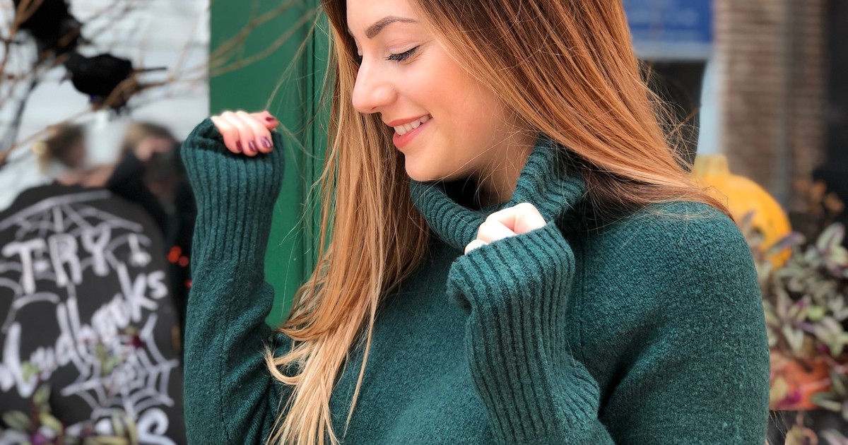 woman wearing emerald turtleneck sweater outside