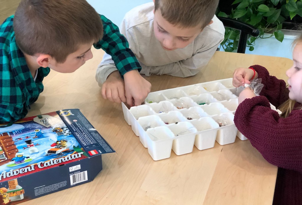 three kids playing with christmas advent calendar