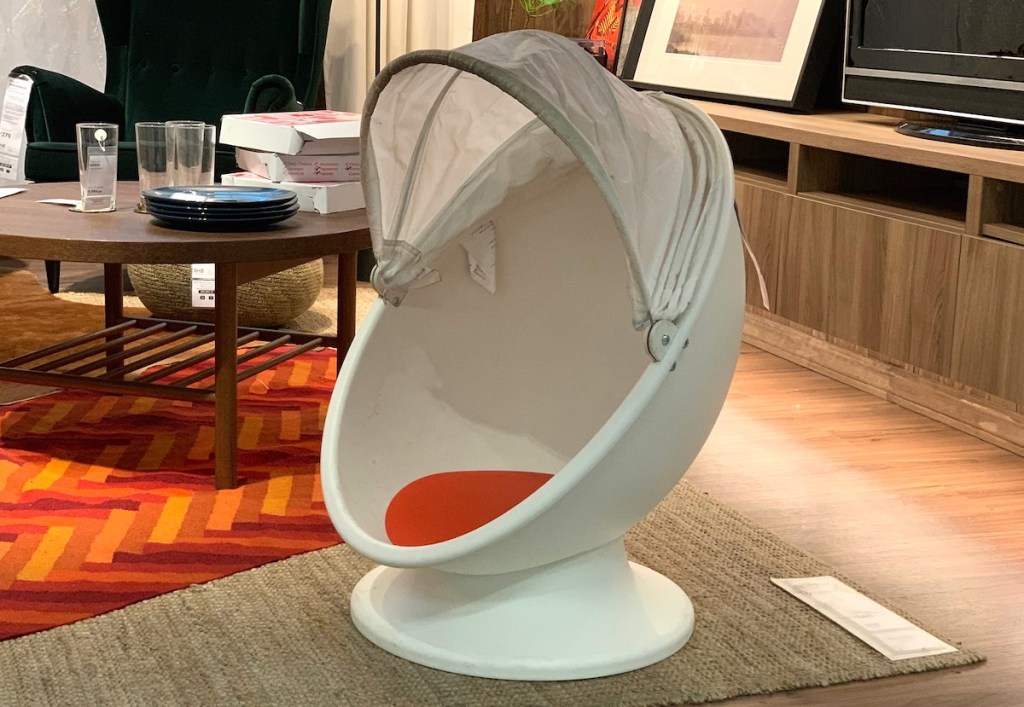 egg shaped swivel kids chair sitting on IKEA showroom living room