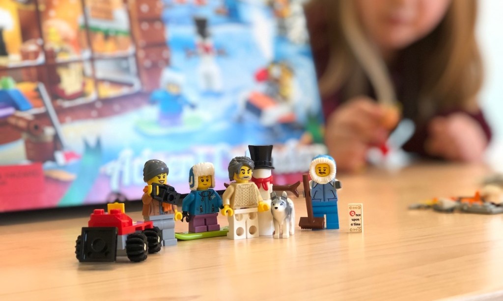 lego people sitting in front of advent calendar box