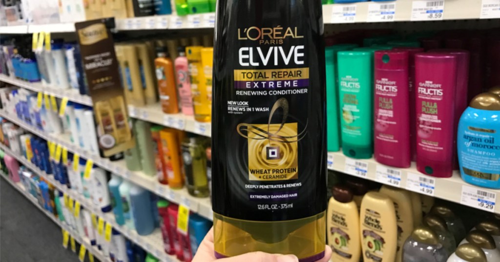 hand holding L'Oreal Elvive Conditioner in store 