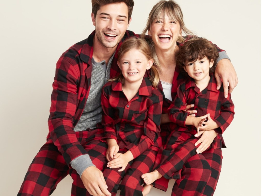 family all wearing black and red plaid flannel pajamas