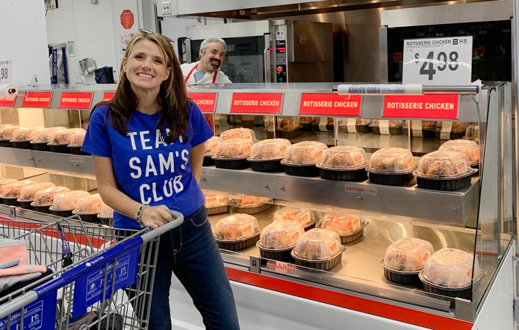 Paige by rotisserie chickens at Sam's Club