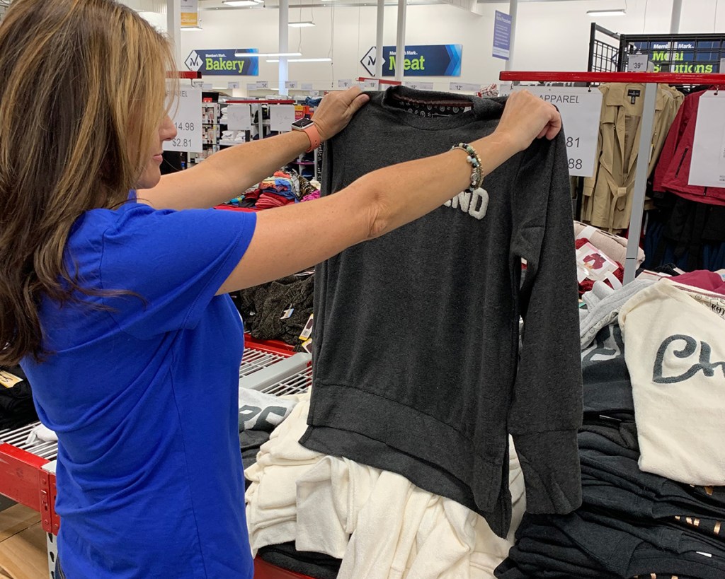 Paige holding up sweatshirt from Sam's Club