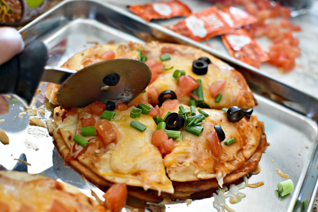 slicing a homemade taco bell mexican pizza