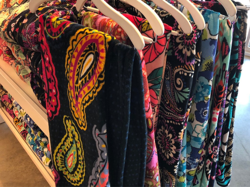 vera bradley throw blankets hanging in store