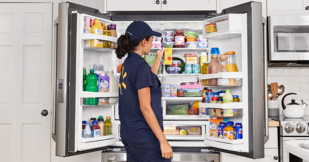 Walmart associate at refrigerator