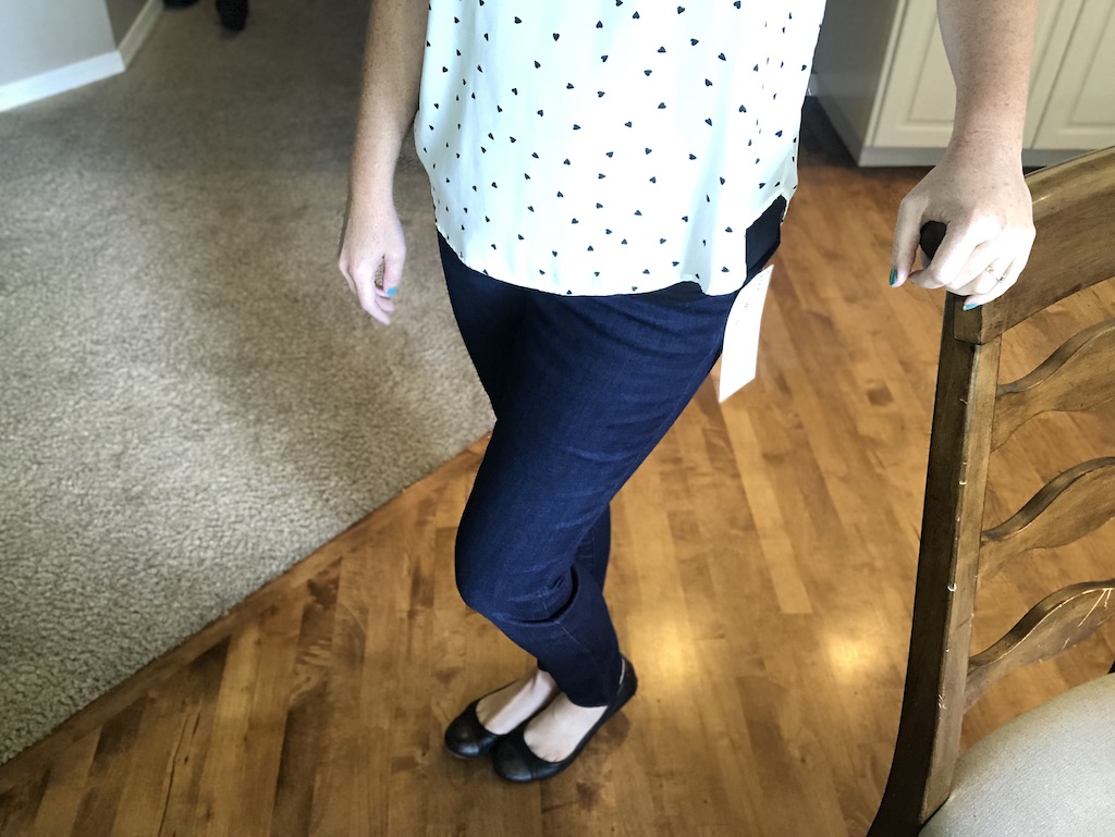 woman standing with skinny jeans and flats 