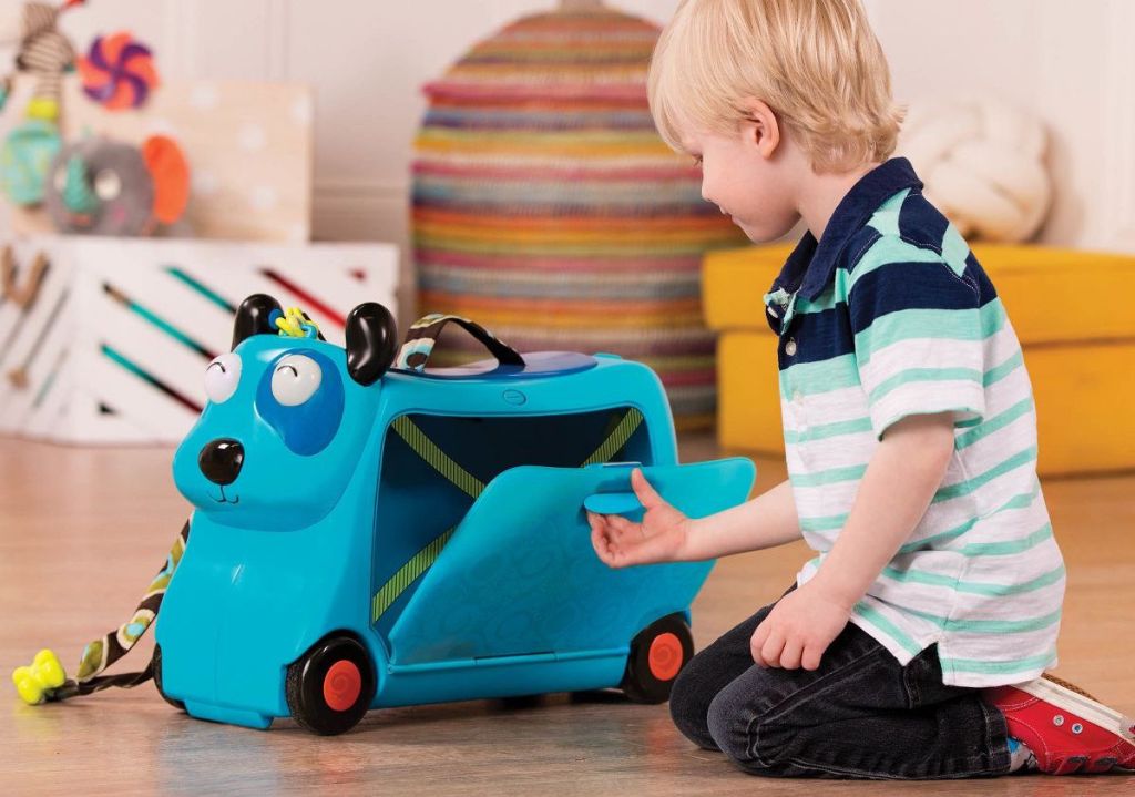 boy playing with B. toys Hound Dog Storage Ride-On