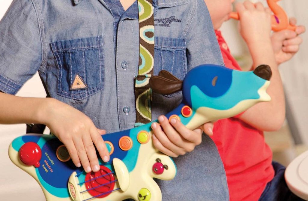 boy playing with B. toys Woofer