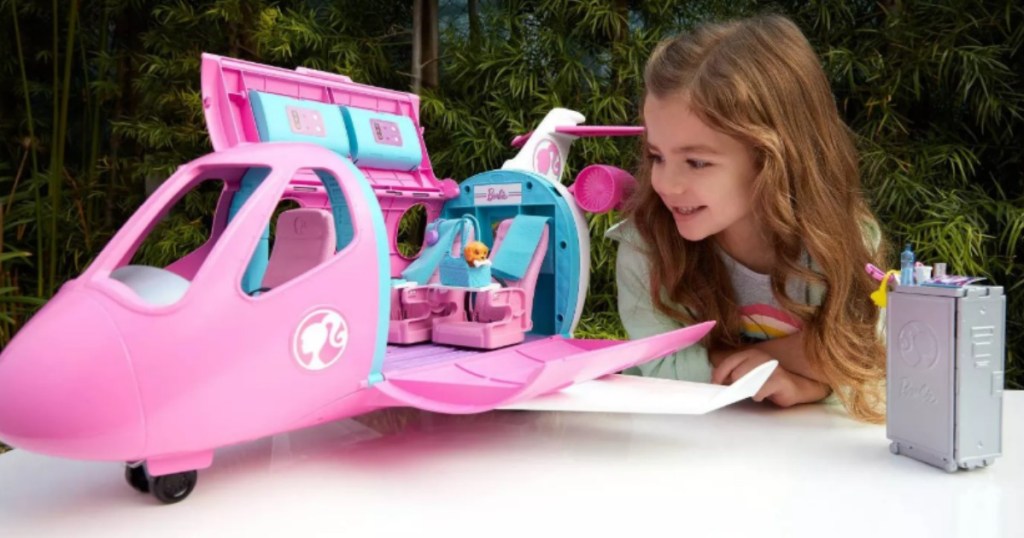 girl playing with Barbie Dream Plane