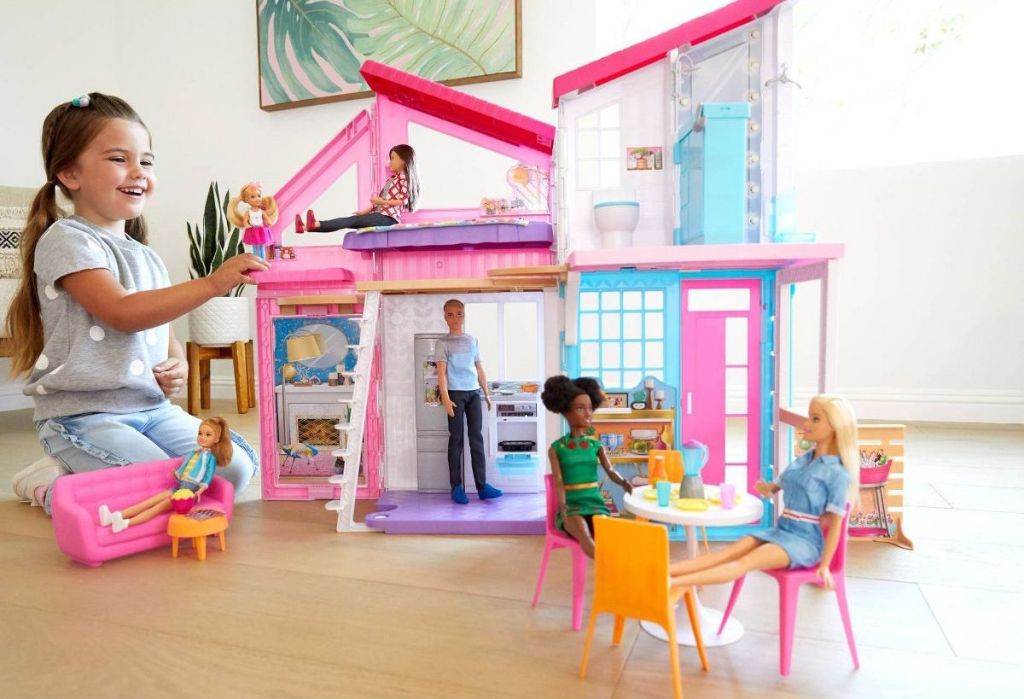 girl playing with Barbie Malibu House Doll Playset