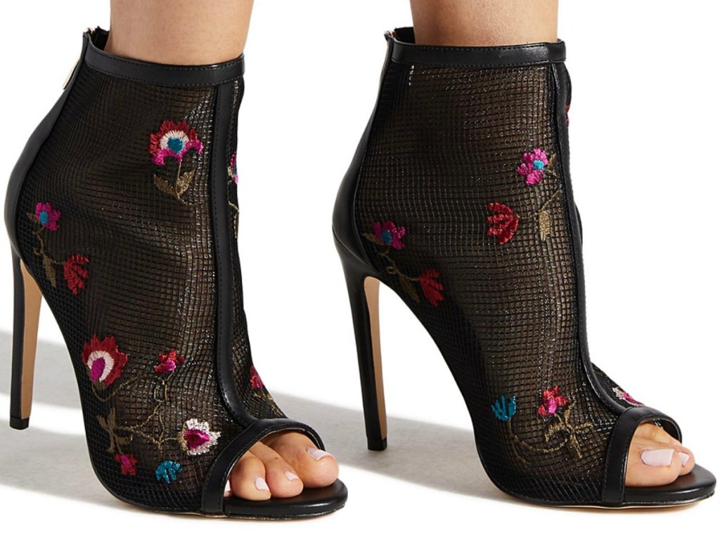 Woman wearing floral mesh booties