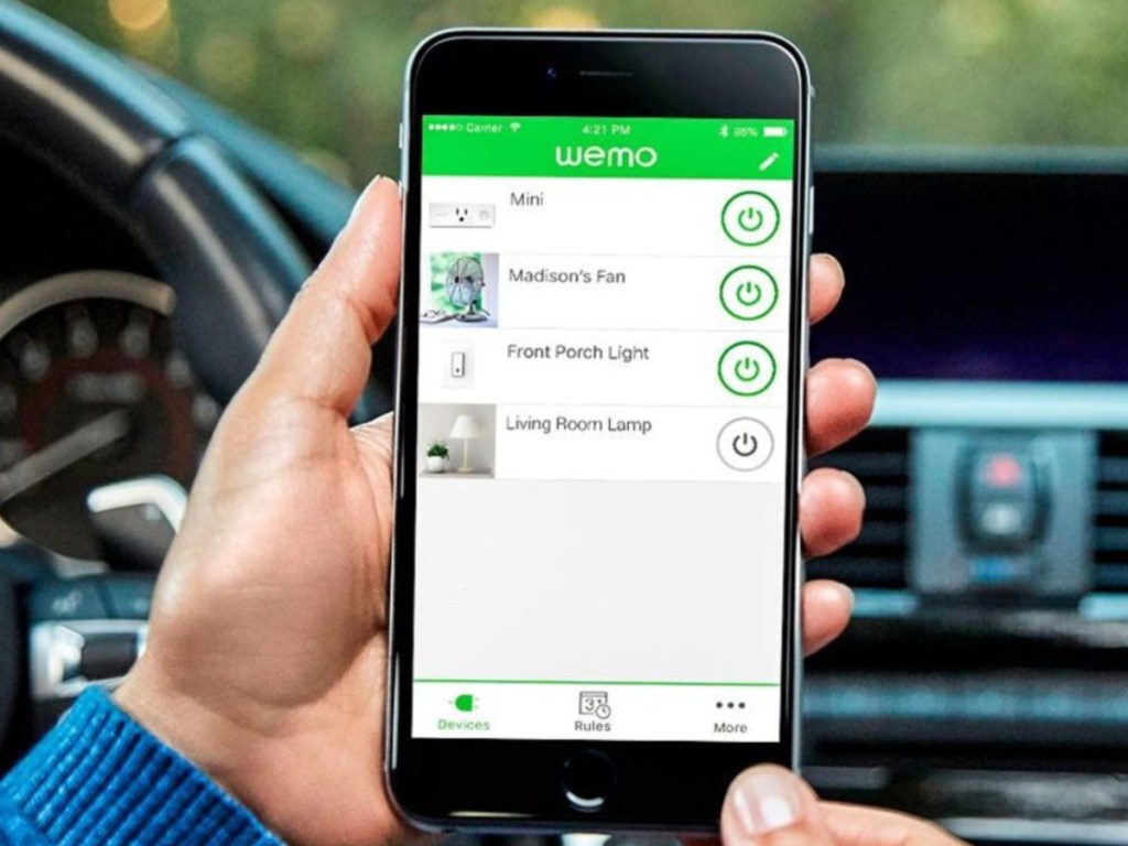 Hand holding smartphone showing wemo app