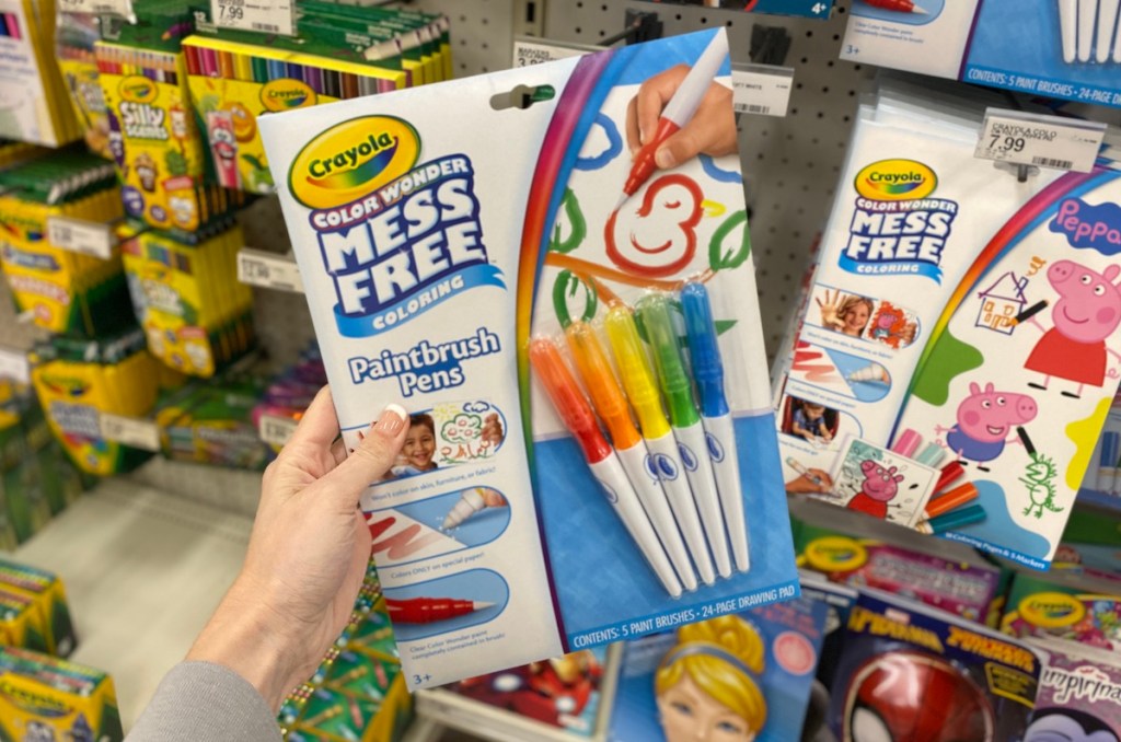 hand holding Crayola Paintbrush Pens set