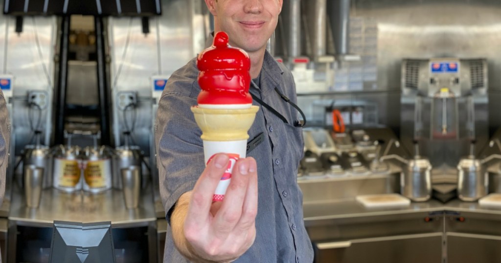 Dairy Queen employee holding Cherry Dipped Cone